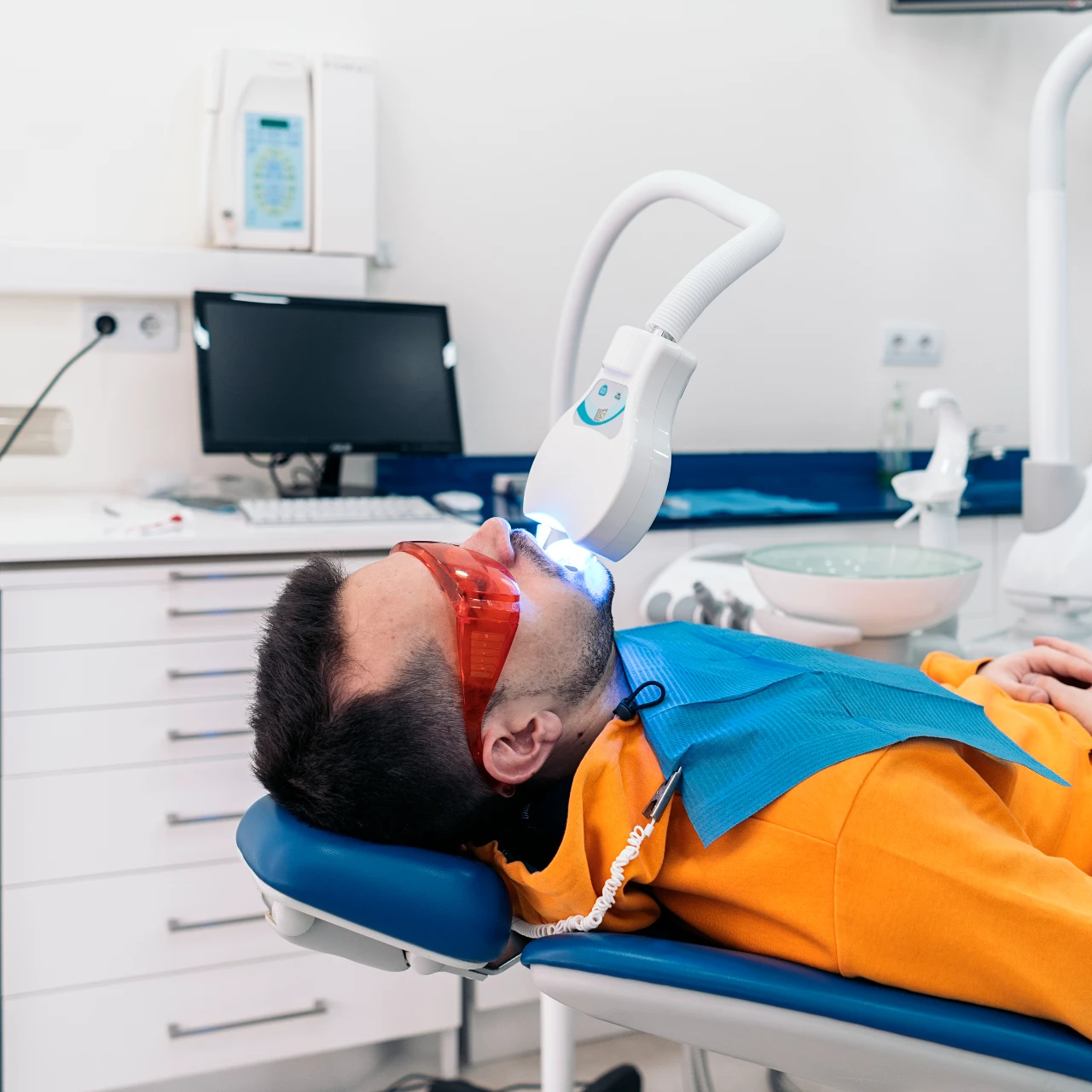 man in dental chair getting professional teeth whitening