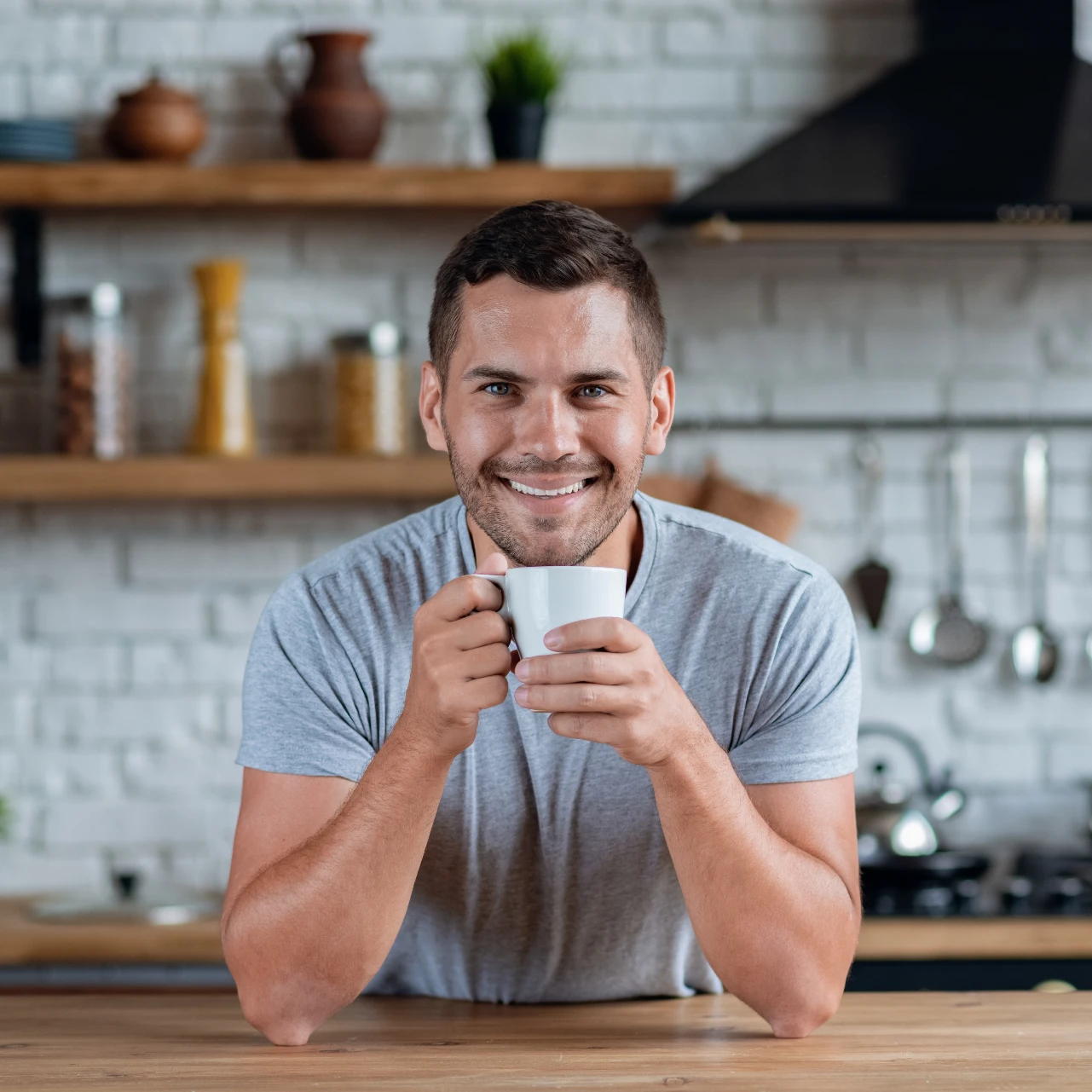 man smiling with coffee after professional teeth whitening